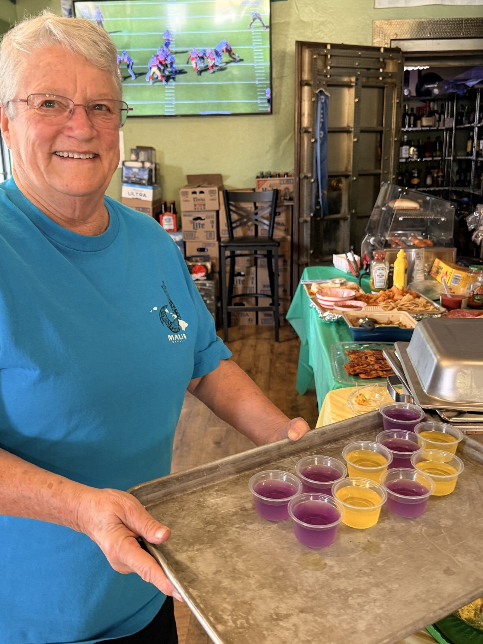 A bartender carries a tray of Jell-O shots